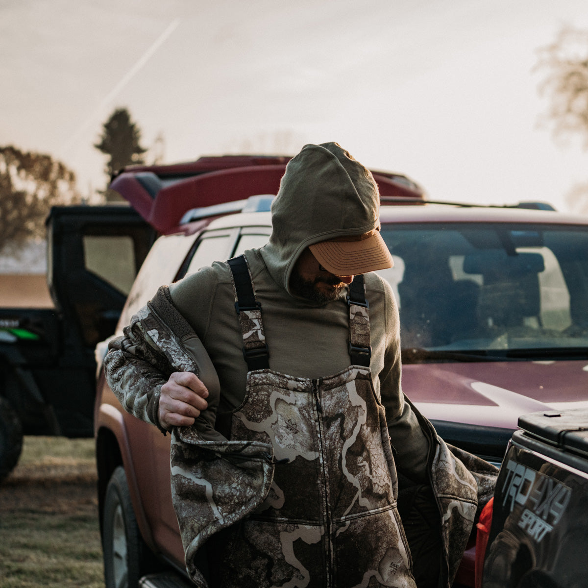 hunter putting ridge bib on at the car