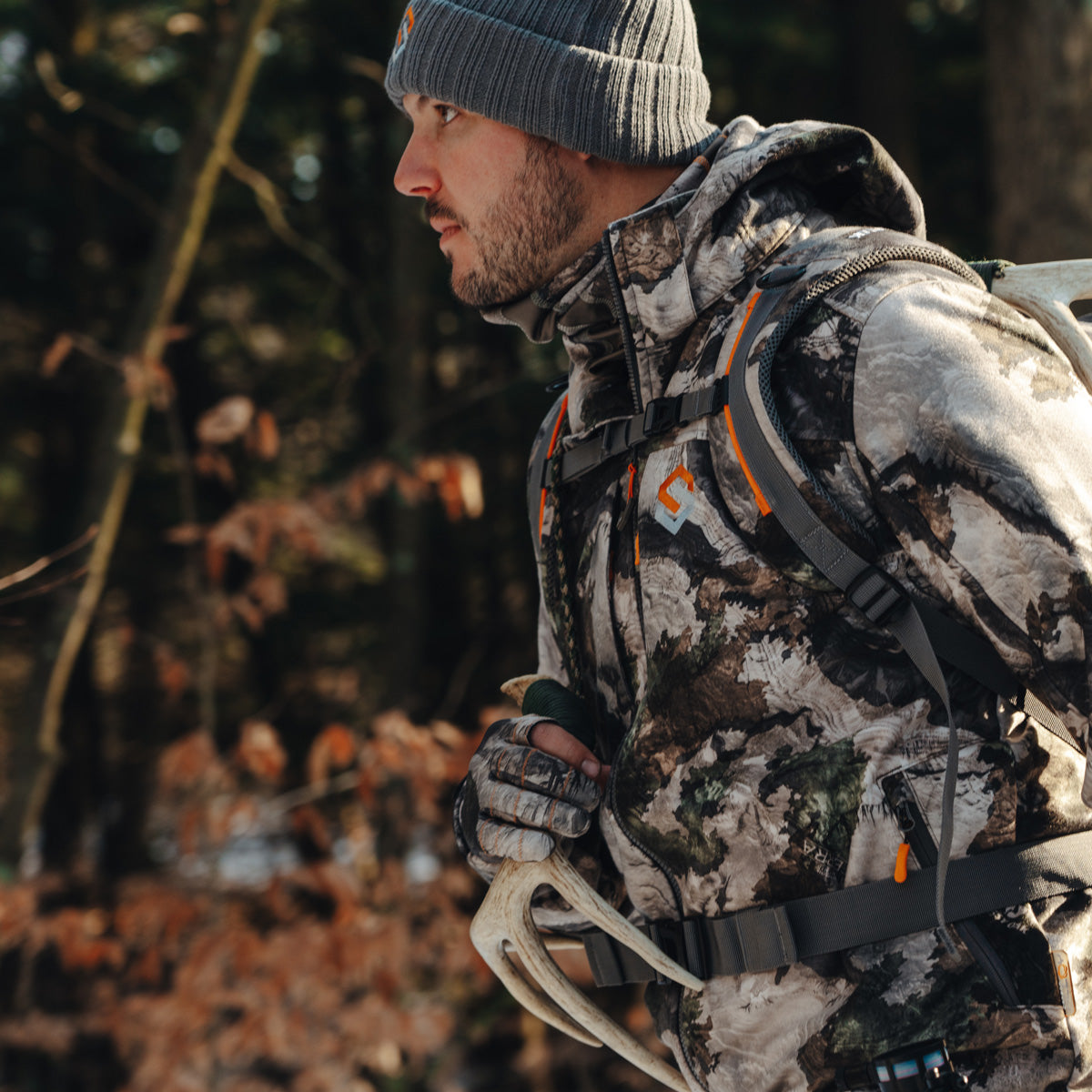 hunter wearing paradigm walking in the woods
